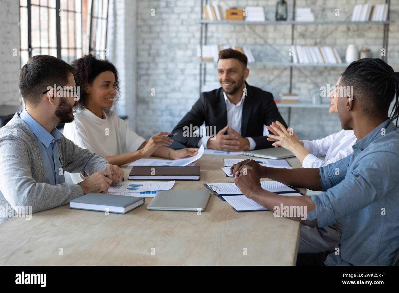 Positive young office workers having a meeting Stock Photo