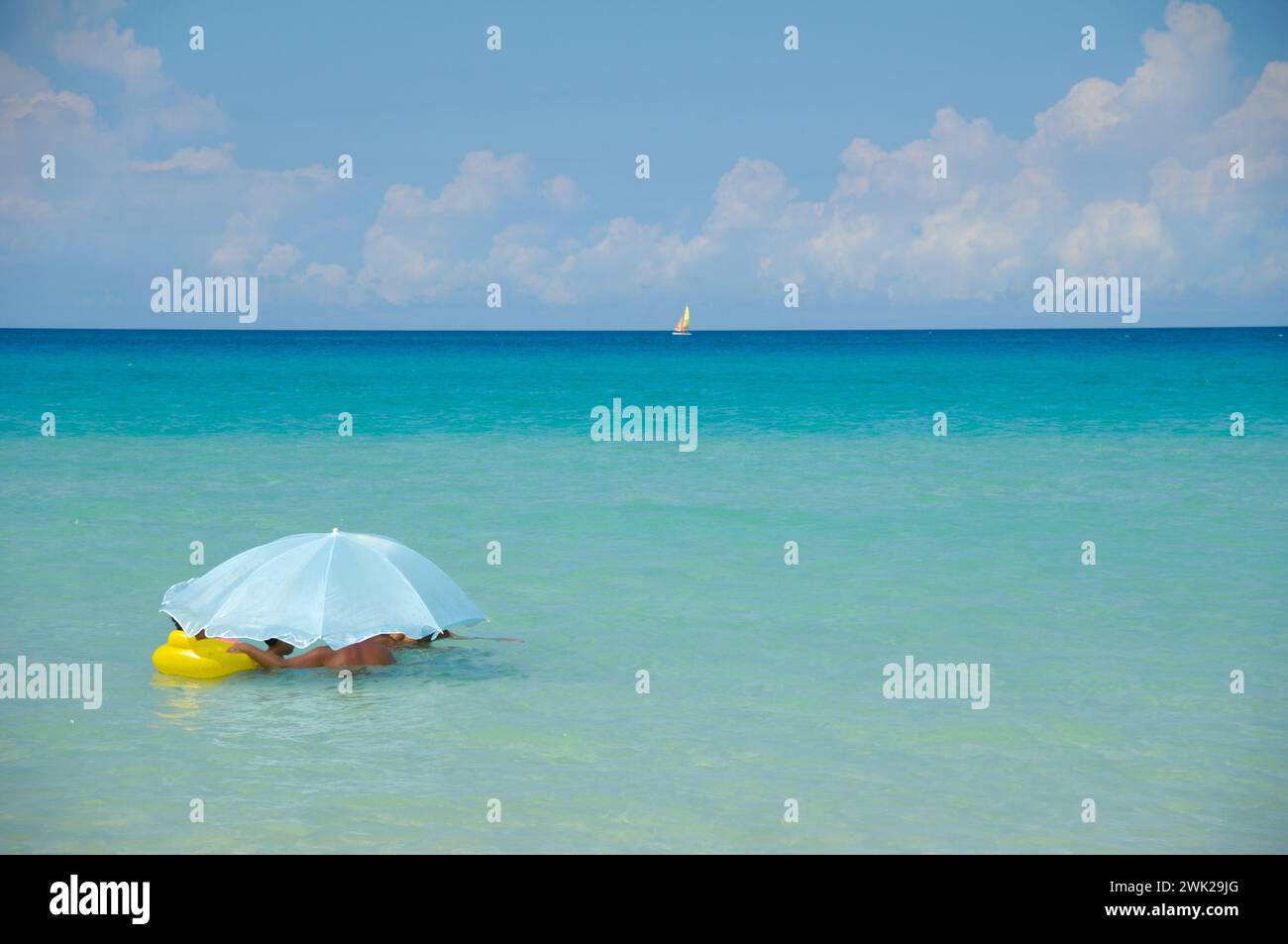 People are under parasol at exotic beach Stock Photo Alamy