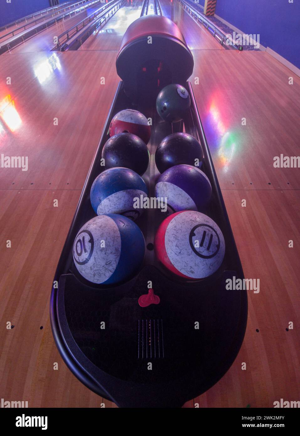 Bowling balls ready on rack. Four lane bowling alley Stock Photo Alamy