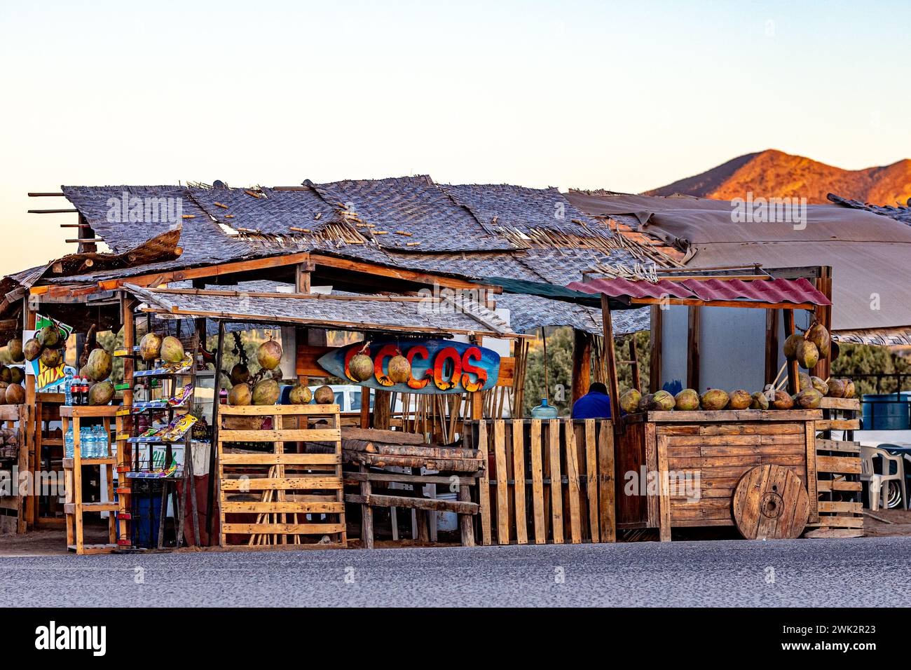 La Paz, Baja California Sur Mexico. February 6, 2023. Coastal tropical drinks stand, wooden construction, selling coconuts, sunny sunset on Mexican El Stock Photo