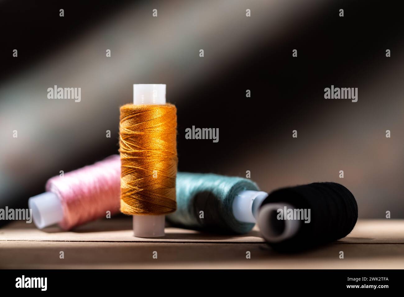 Several spools of thread. Multi-colored spools of thread. Thread for seamstresses. Front view. Stock Photo