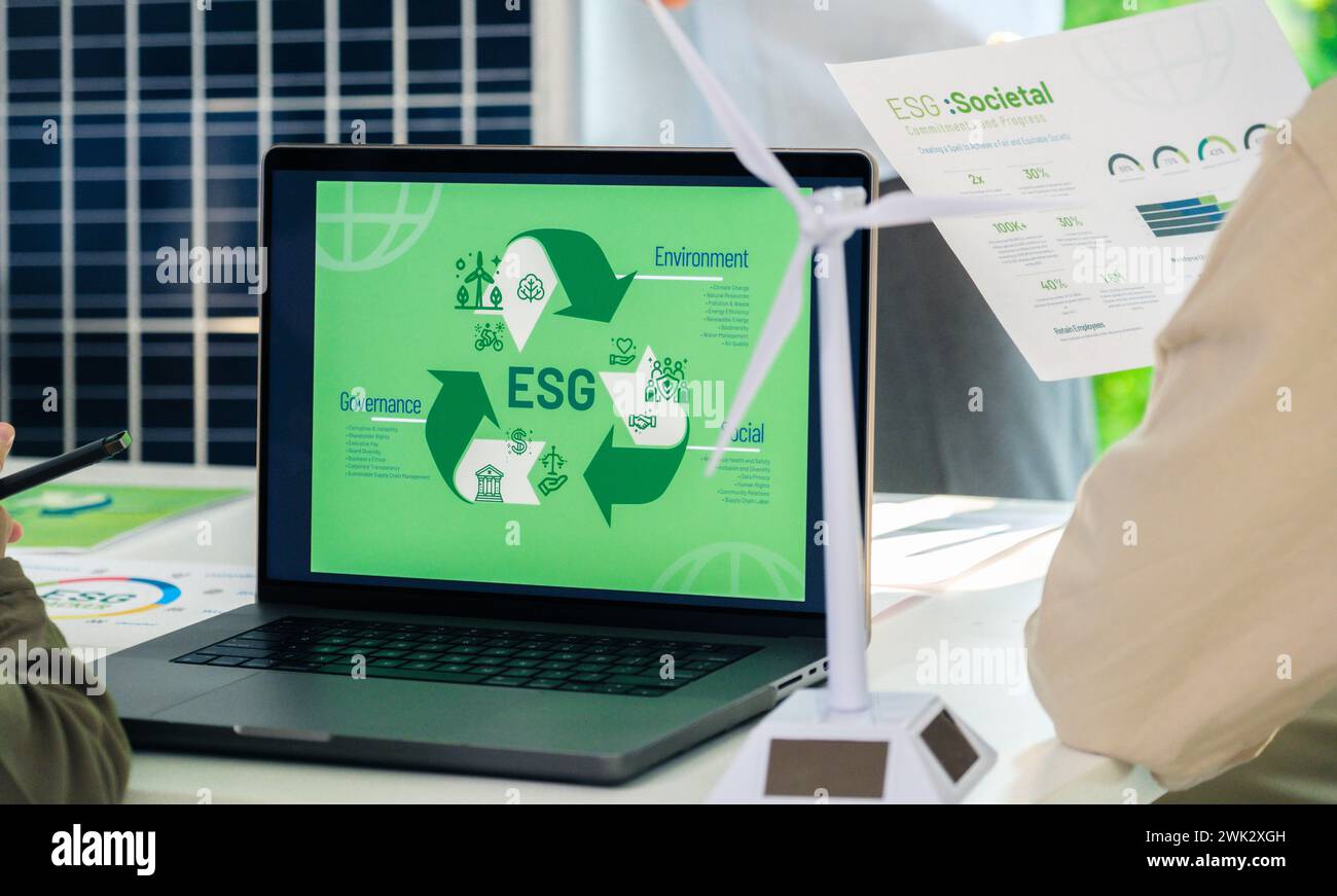 ESG ( environment, social,governance) recycle sign on laptop screen with carbon free chart board in office Stock Photo
