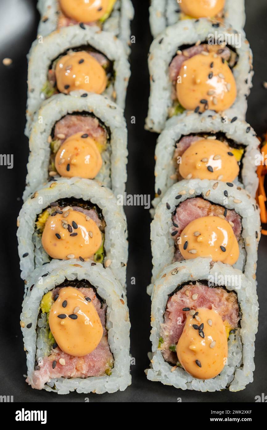 A closeup of sushi roll with tuna and Sriracha mayo sauce Stock Photo
