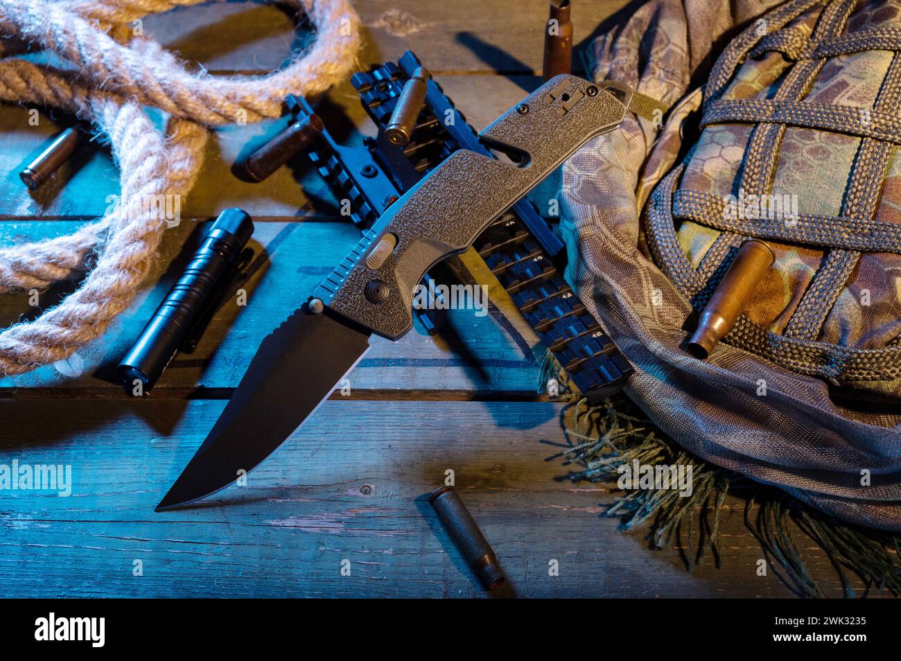 A folding knife with a green handle and a black blade. Military ...