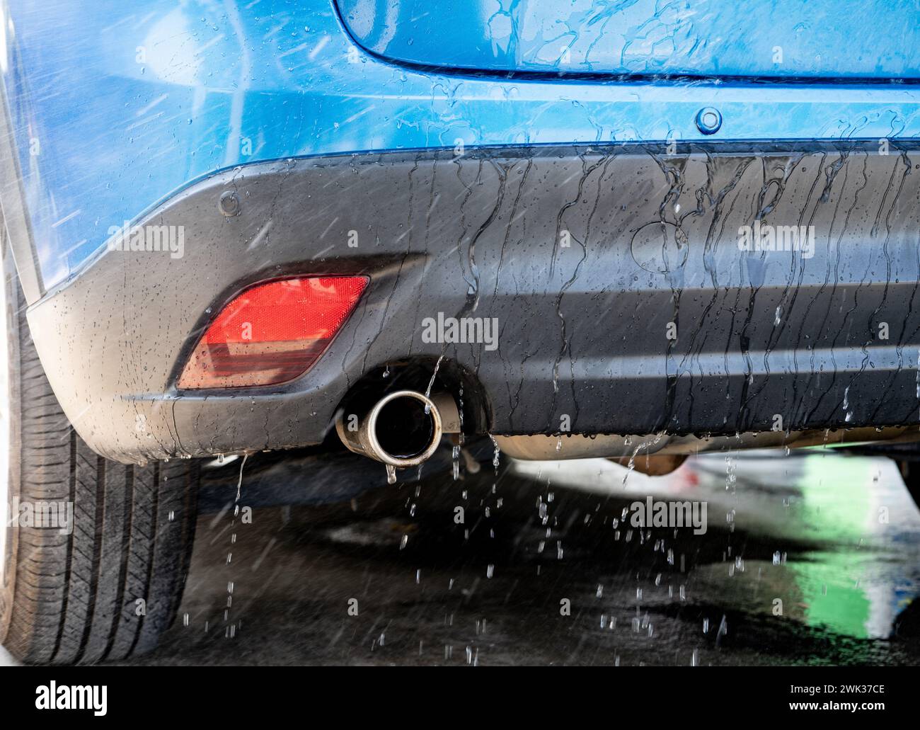Car washing with spray water. Car cleaning. Auto care service concept. Vehicle cleaning. Cleaning with spray water for vehicle care and maintenance. Stock Photo