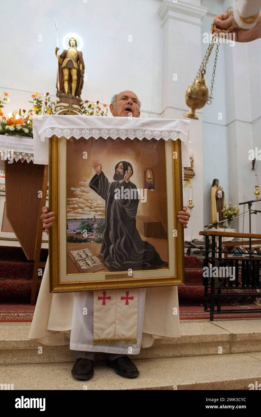 Father Antonio with the image of Saint Maron in the church of Kormakitis. Stock Photo