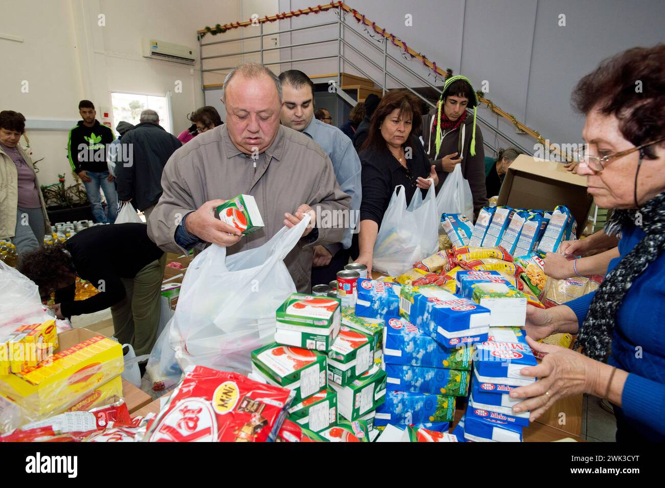 In the village of Latsia, near Nicosia, people with very low income receiving free food donated by the Church of Cyprus. Stock Photo
