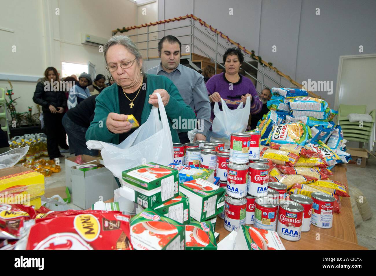 In the village of Latsia, near Nicosia, people with very low income receiving free food donated by the Church of Cyprus. Stock Photo