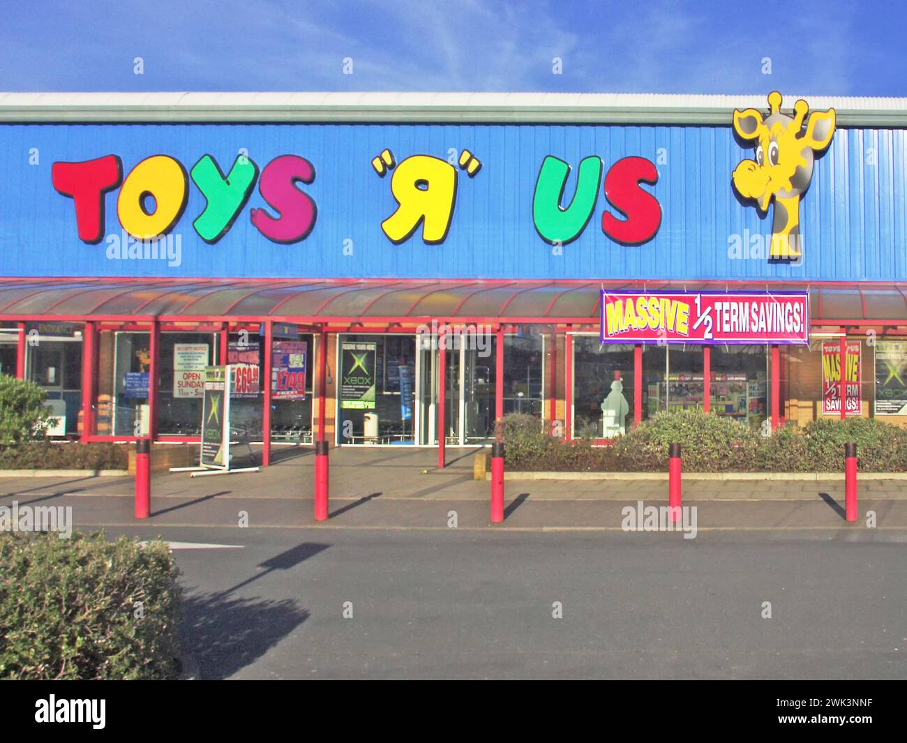 Toys R Us a retail toy business store & close up of logo brand sign on 1900s historical archive shop sign featuring Geoffrey Giraffe the official mascot later to be excluded from UK stores as shown in Alamy image ref E54G48 & C3X2JX, ( The company filed for bankruptcy in 2017 and 2018, closing all UK stores) Note that date taken is very approximate Stock Photo
