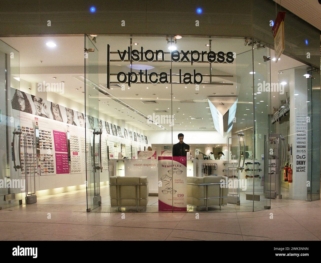 Shop front signage in Canary Wharf London Docklands historical archive view of one of the early business uptakes in new units in shopping mall below the One Canada Square area with Vision Express Optical Lab sign on fully glazed window frontage in Canada Place Isle of Dogs in the London Borough of Tower Hamlets East End England UK Stock Photo