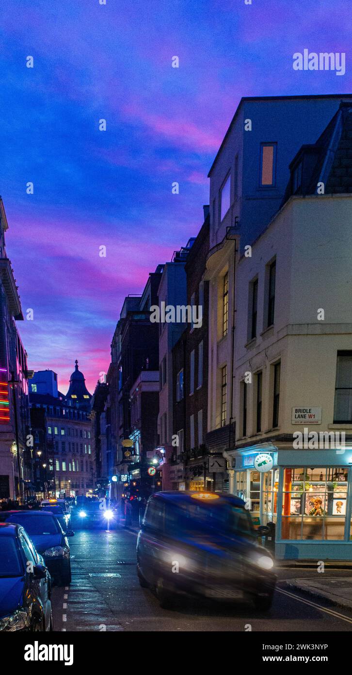 Brewer Street in Soho, London at night with a dramatic sunset Stock Photo