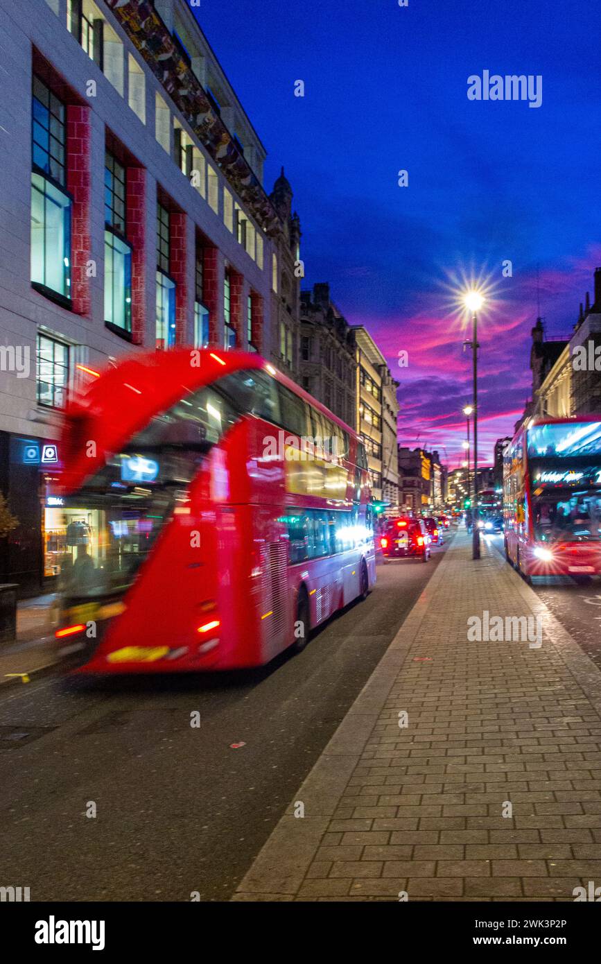 A blurred bus in traffic on Picadilly in London with a dramatic sunset Stock Photo