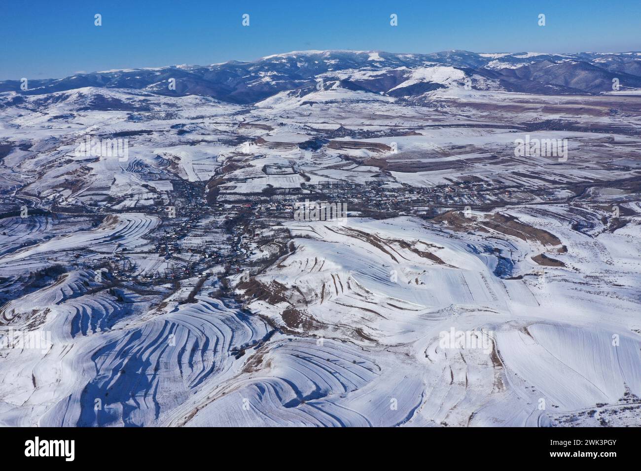 Aerial drone view of snow covered countryside hills and meadow Stock Photo