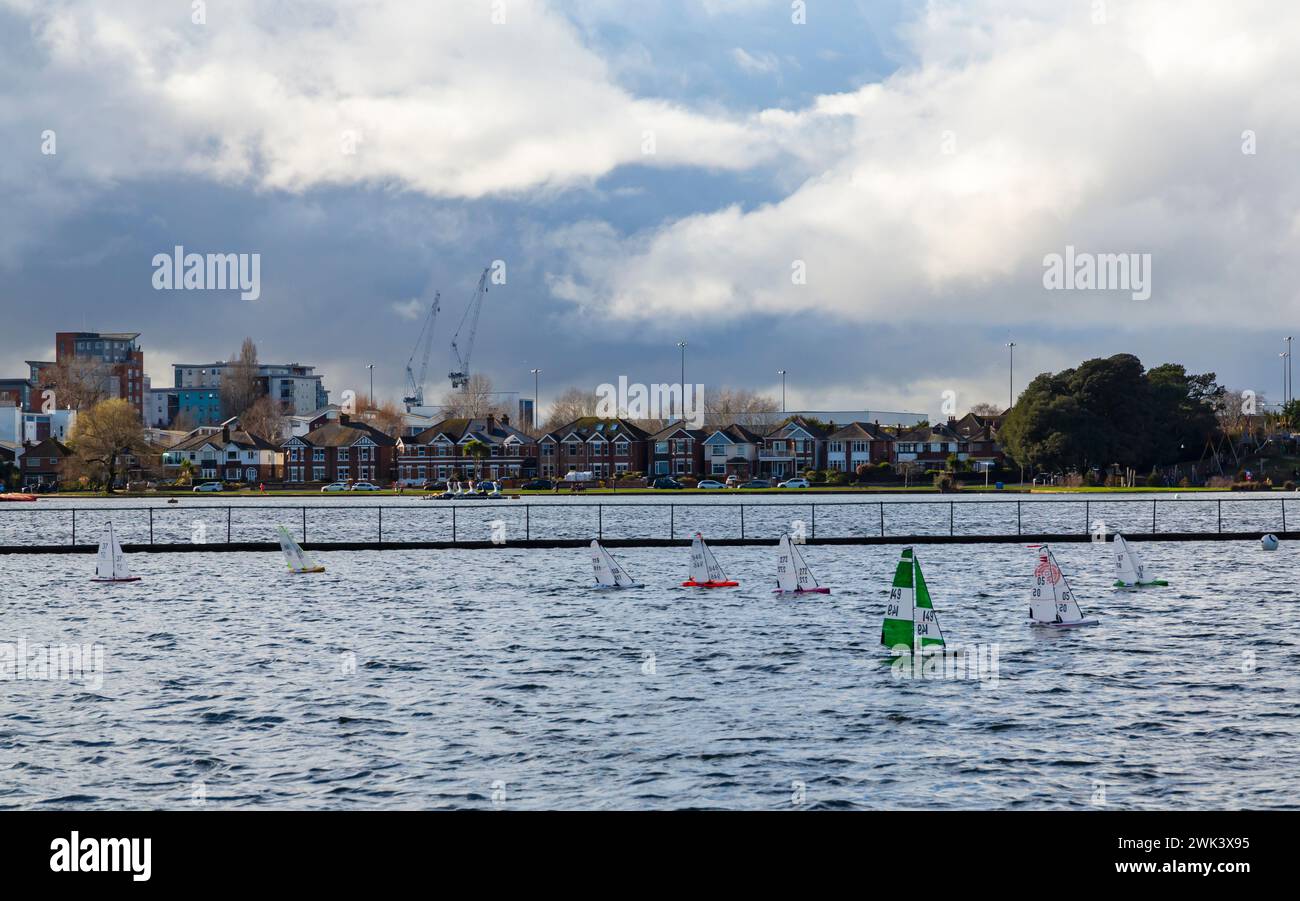 Poole, Dorset UK. 18th February 2024. UK weather: changeable weather - after a night of heavy rain the sun comes out in the afternoon with a mixture of sunshine and showers, feeling warm with a breeze. Visitors head to Poole Park to make the most of the sunshine. Radio controlled boat enthusiasts race their model boats around Poole Park lake. Credit: Carolyn Jenkins/Alamy Live News Stock Photo