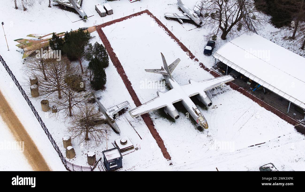 Aerial view of snow-clad tanks, artillery, armored vehicles, military vehicles, and airplanes in Poznan Citadel during winter, shot by drone. Stock Photo