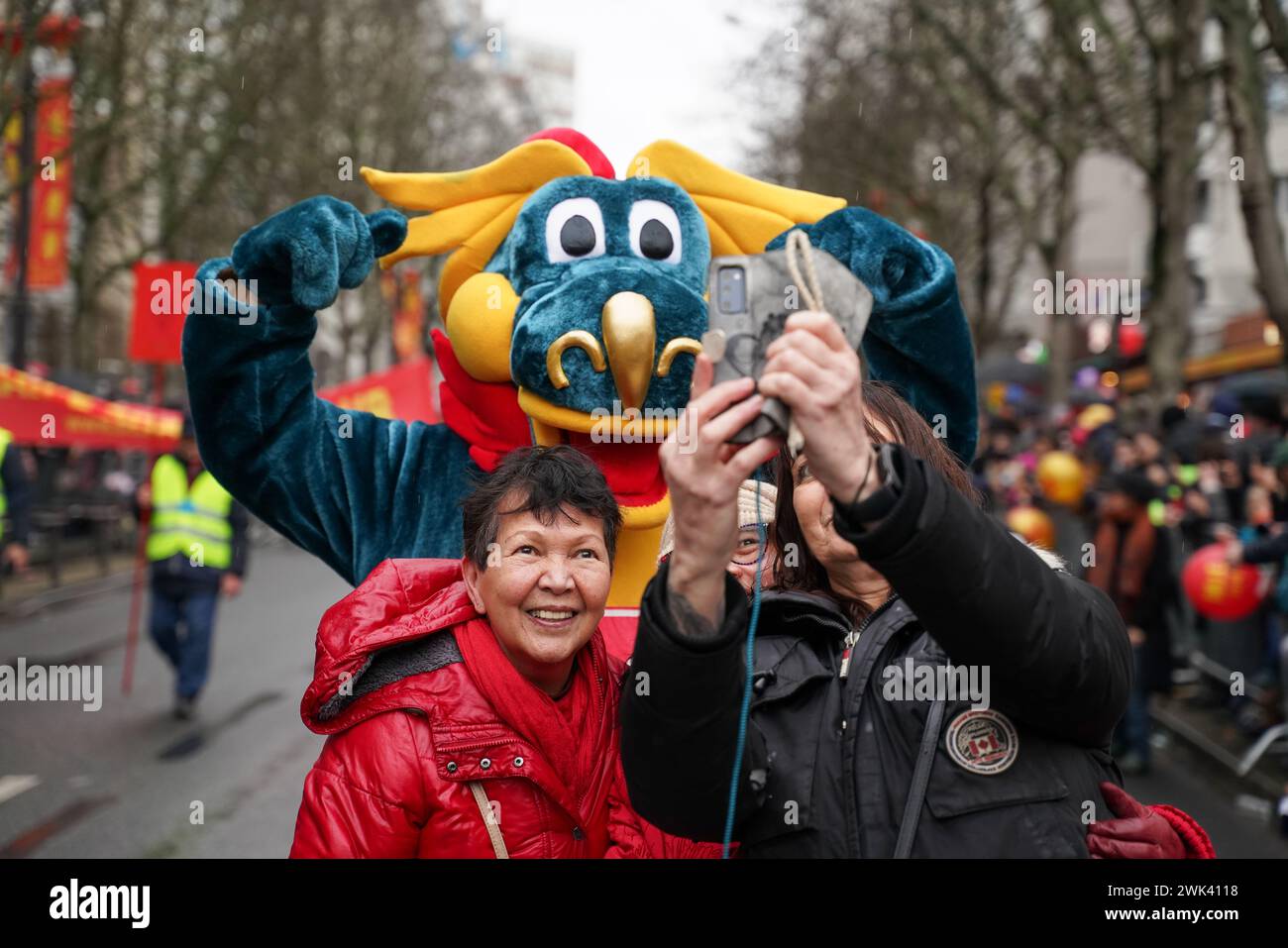 Paris, France, 18th February, 2024. People making a selfie with dragon during Chinese New Year celebration - Jacques Julien/Alamy Live News Stock Photo