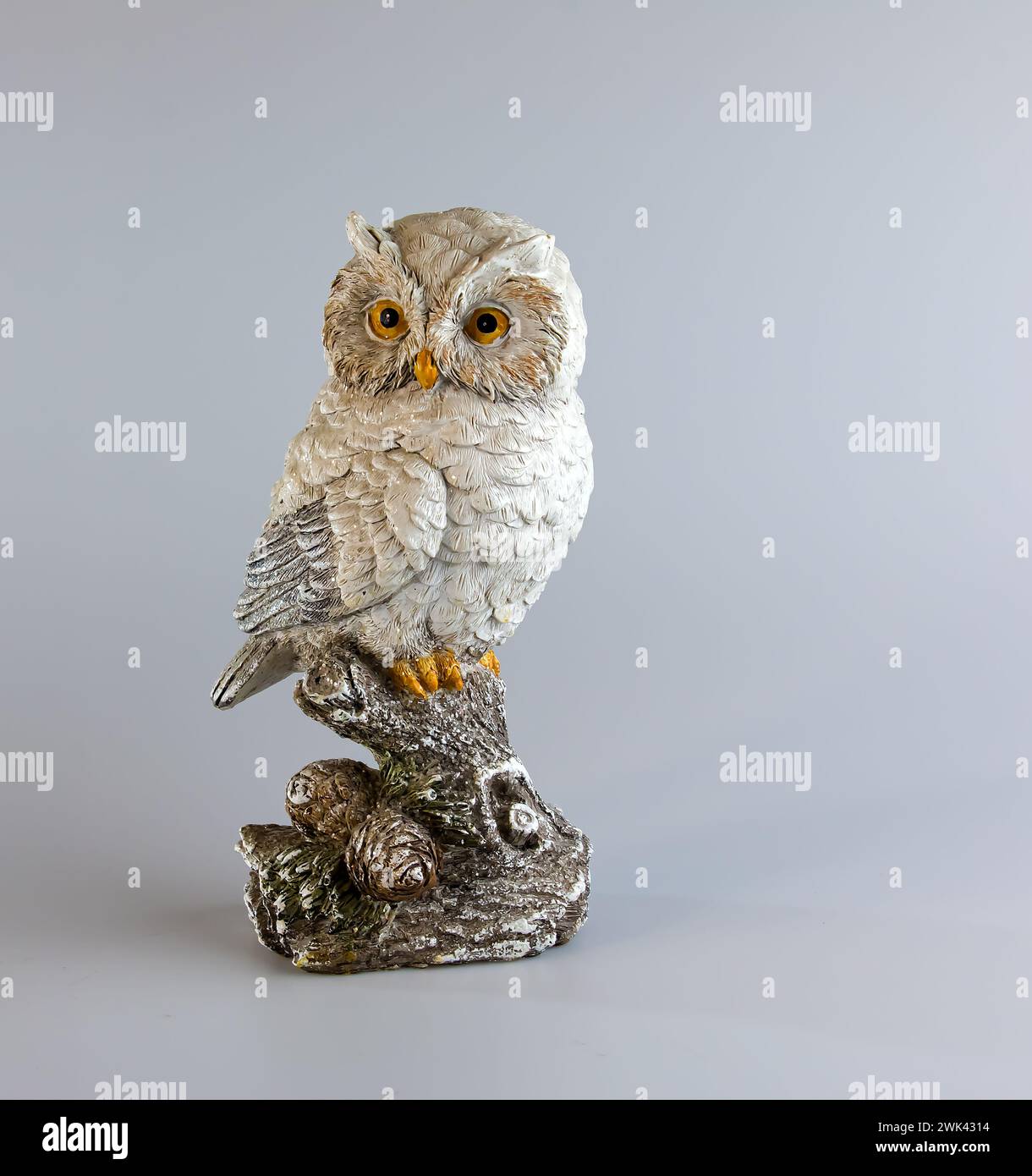 Ceramic owl figurine on a white background. Selective focus. Copy space. Stock Photo