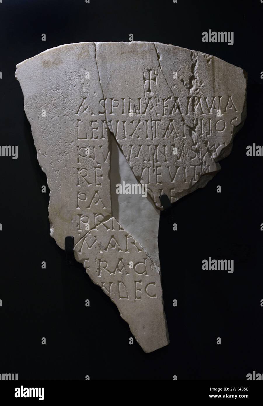 Fragment of the Aspidia tombstone. It shows a Chrismon and an inscription in capital letters. Marble. 6th century. Provenance unknown. Museum of Visigoth Councils and Culture. Toledo, Castile-La Mancha, Spain. Stock Photo