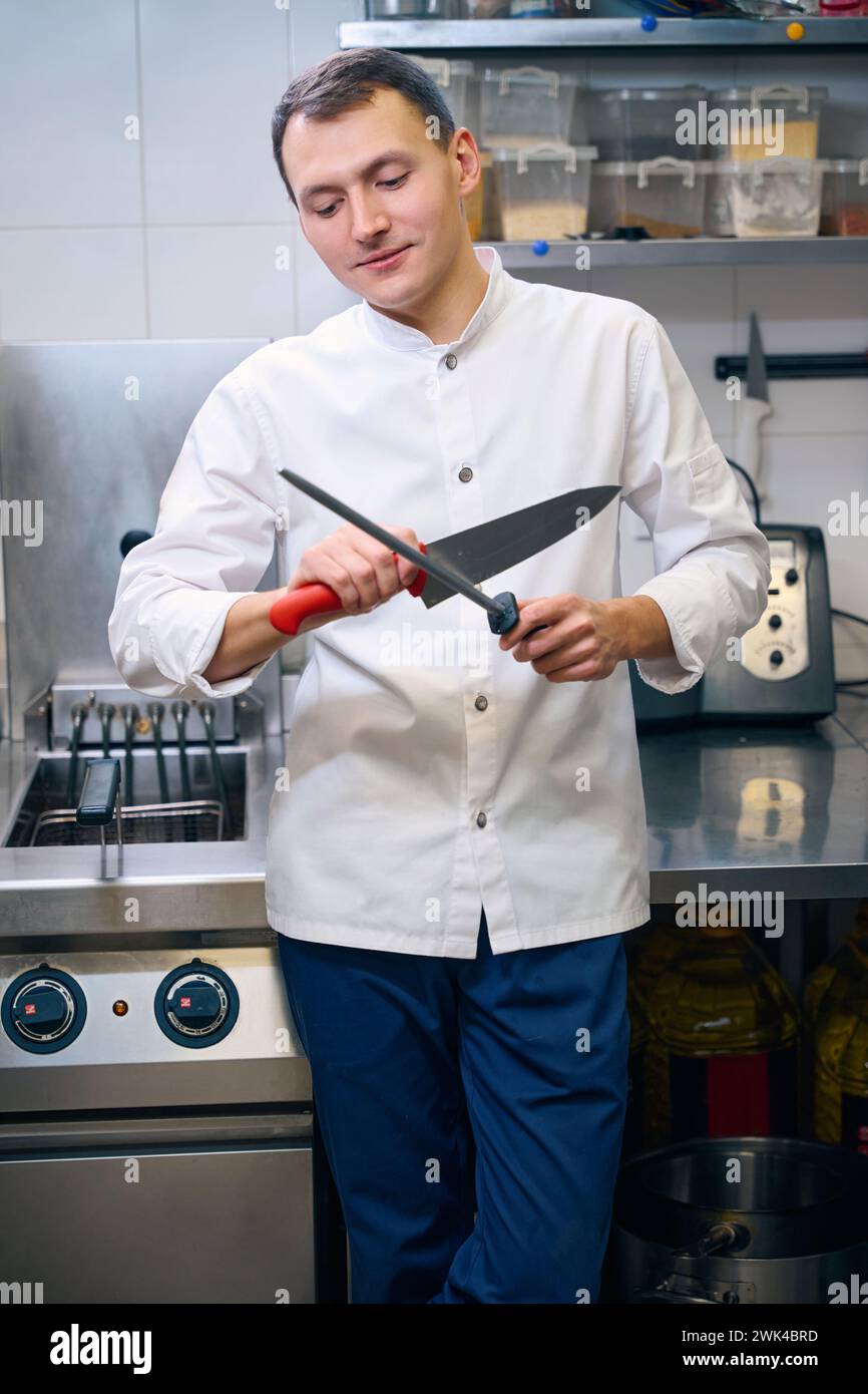 Male cook sharpening knife hi-res stock photography and images - Alamy