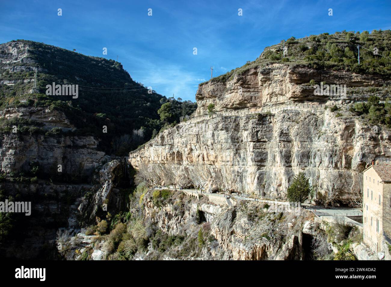 Sant Miquel del Fai is an 11th-century Benedictine monastery. Cliffs building formation, Catalonia. Beutiful mountain view of hills moody color graded Stock Photo