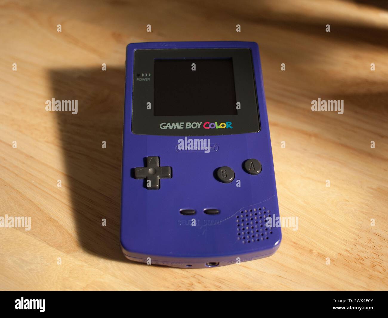 Miami, Florida, United States - November 26, 2023: Vintage Nintendo Game Boy Color handheld console color model Grape (blue) on a table. Stock Photo