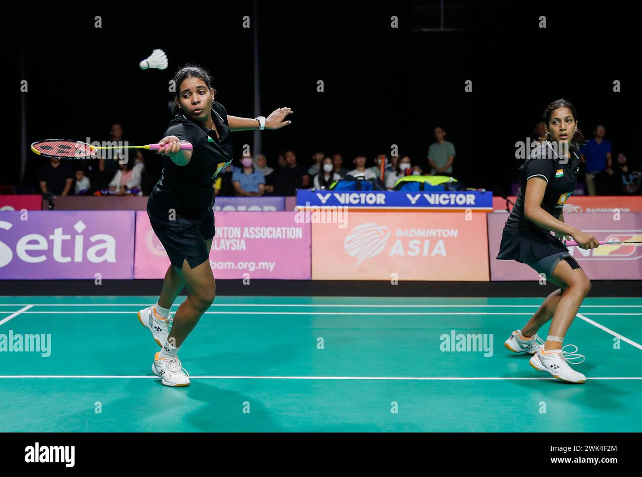 Kuala Lumpur, Malaysia. 18th Feb, 2024. Gayatri Gopichand Pullela and Treesa Jolly (L) of India in action against Jongkolphan Kititharakul and Rawinda Projongjai of Thailand (not pictured) during the Women's Doubles final match at the Badminton Asia Team Championships 2024 at Setia City Convention Centre in Shah Alam. Gayatri Gopichand Pullela and Treesa Jolly won with scores; 21/18/21 : 16/21/16. (Photo by Wong Fok Loy/SOPA Images/Sipa USA) Credit: Sipa USA/Alamy Live News Stock Photo