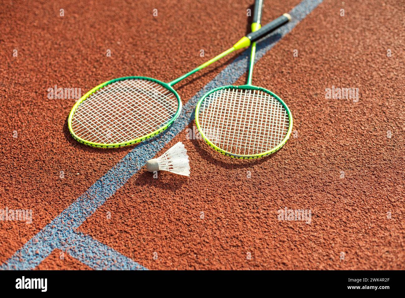 Badminton rackets and feather shuttlecock on the court Stock Photo
