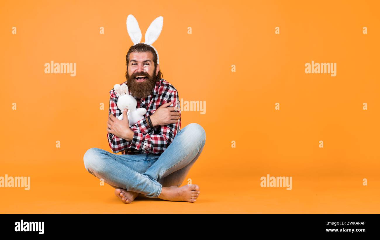 Funny Man Riding A Rabbit funny bearded man wear bunny ears. guy in rabbit costume having fun ...
