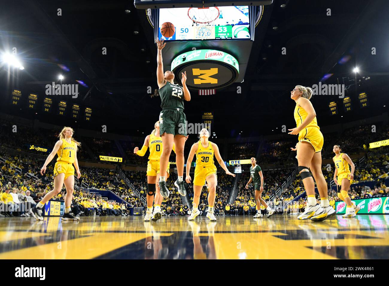 Michigan State guard Moira Joiner (22) scores a basket past Michigan