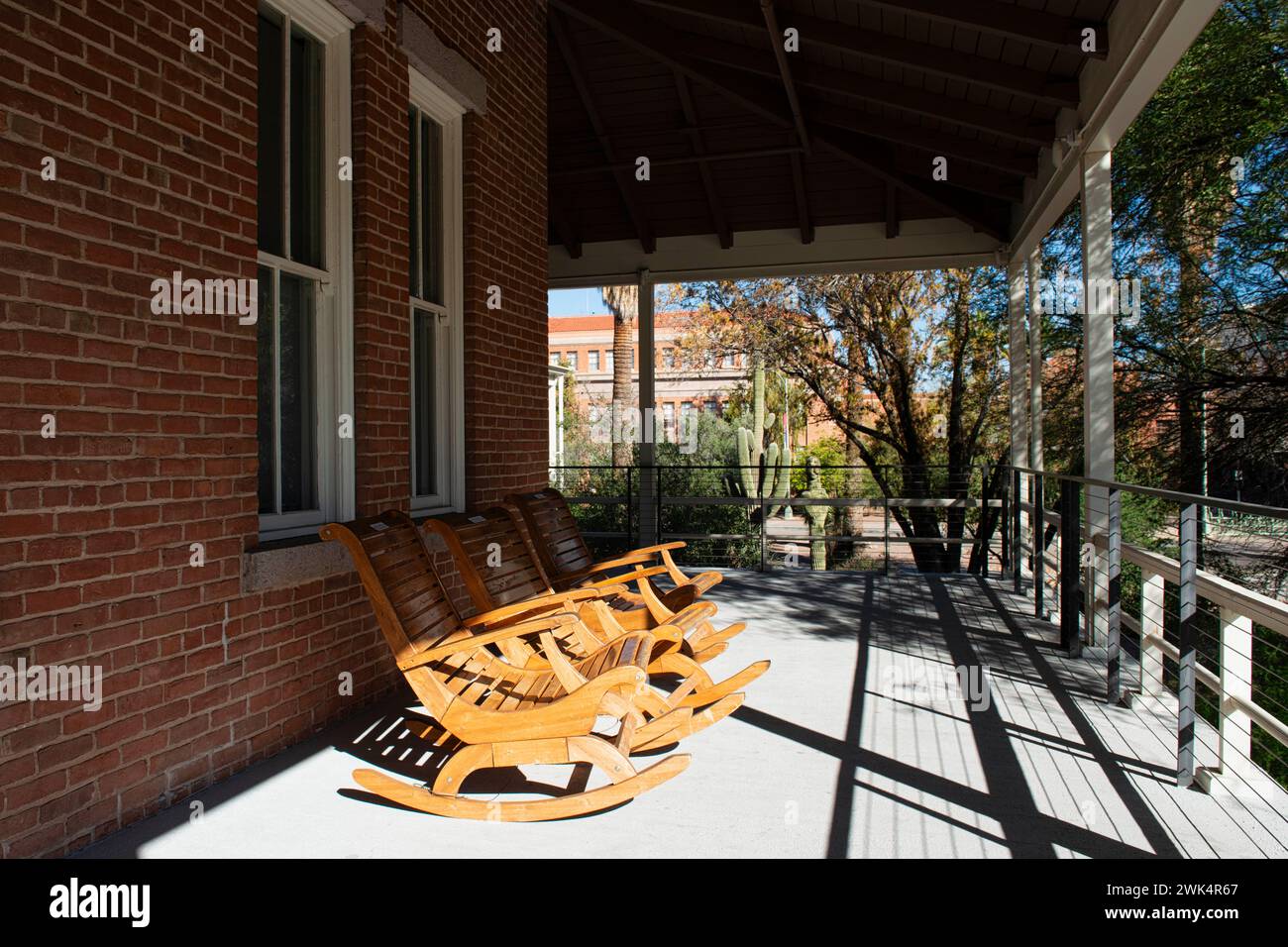 Three Rocking chairs on the porch of Old Main which once served as the only building on the University of Arizona campus Tucson with six teachers Stock Photo