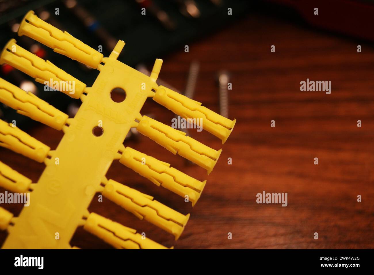 Close-up of yellow plastic dowels. Installation and construction. Stock Photo