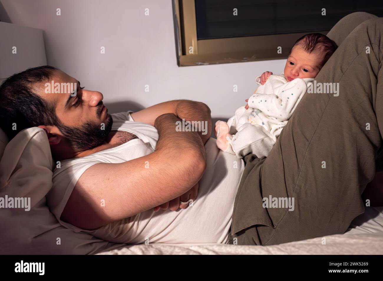baby wake up during night and prevent parents from getting some sleep Stock Photo