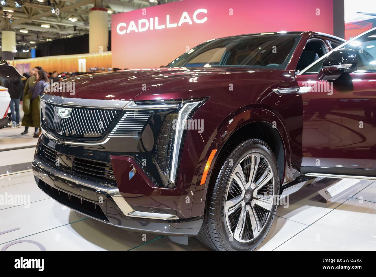 Side view of design in the headlights, grille, and wheel of a red Cadillac Escalade electric car Stock Photo
