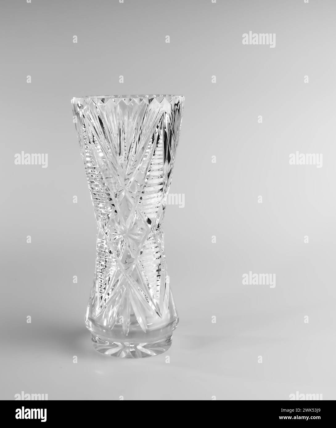 Empty crystal vase on white background. The vase was made in the mid