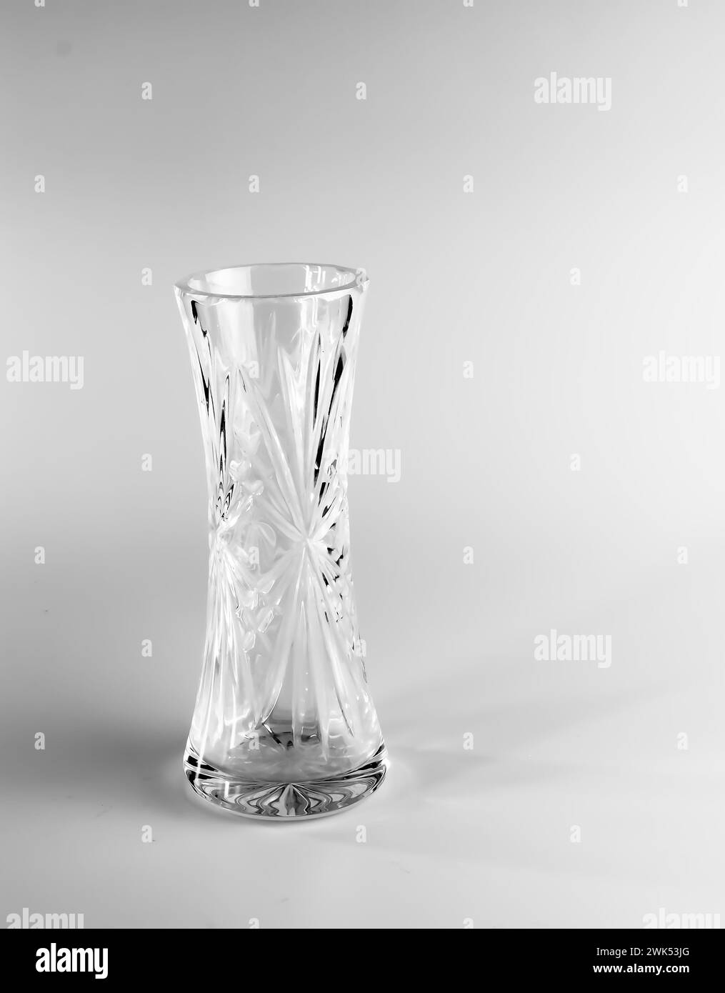 Empty crystal vase on white background. The vase was made in the mid