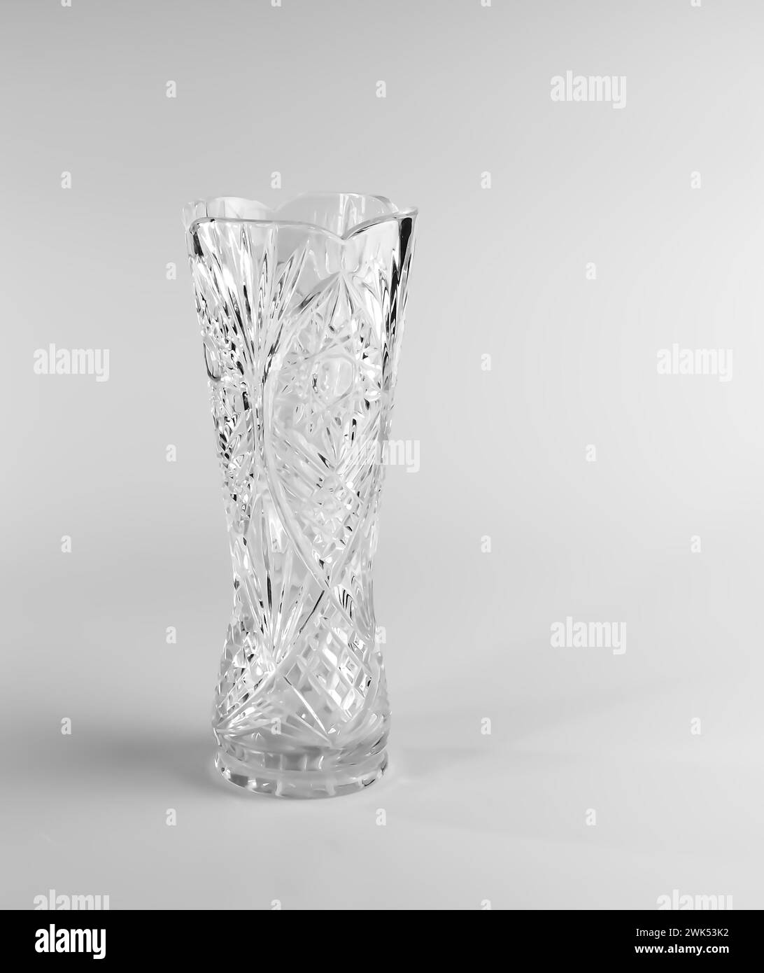 Empty crystal vase on white background. The vase was made in the mid