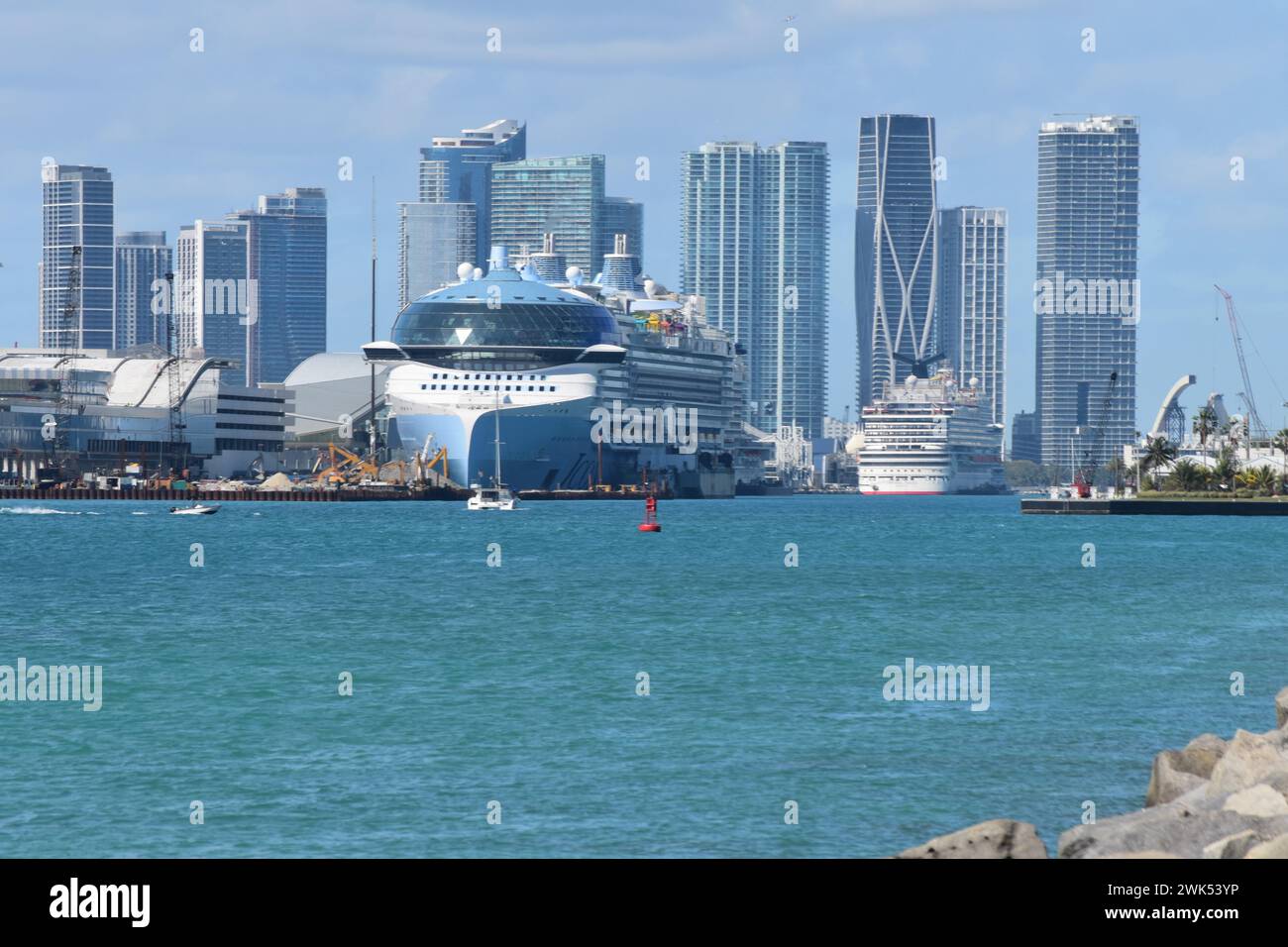 The world's largest cruise ship, Icon of the Seas, docked at PortMiami, against a backdrop of the skyscrapers of Brickell & Downtown Miami, Feb. 2024. Stock Photo