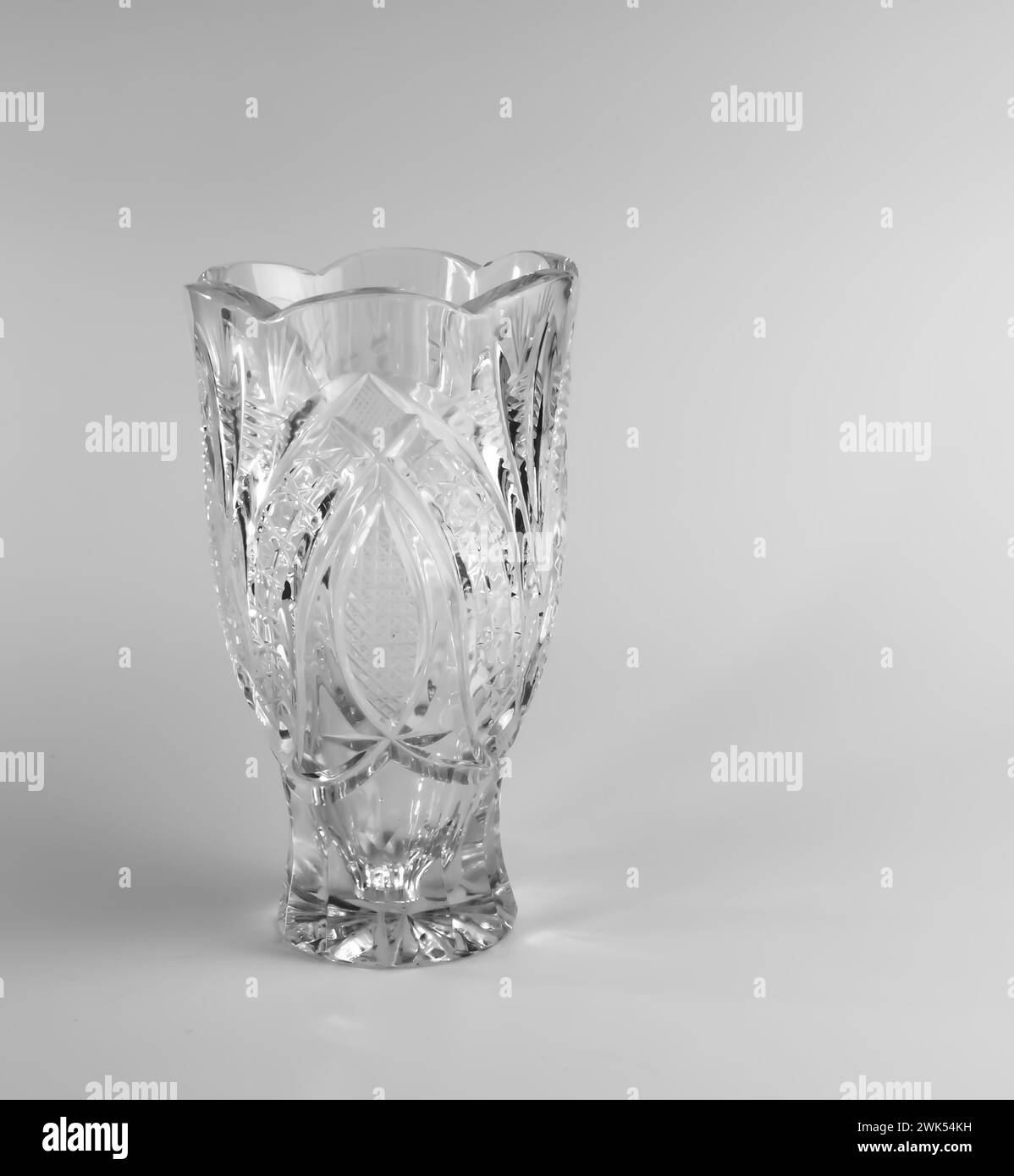 Empty crystal vase on white background. The vase was made in the mid