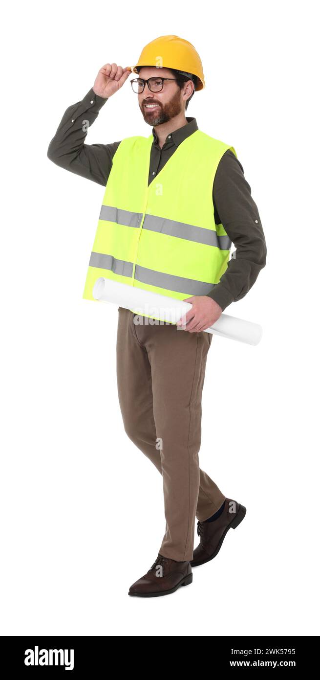 Architect in hard hat with draft walking on white background Stock Photo