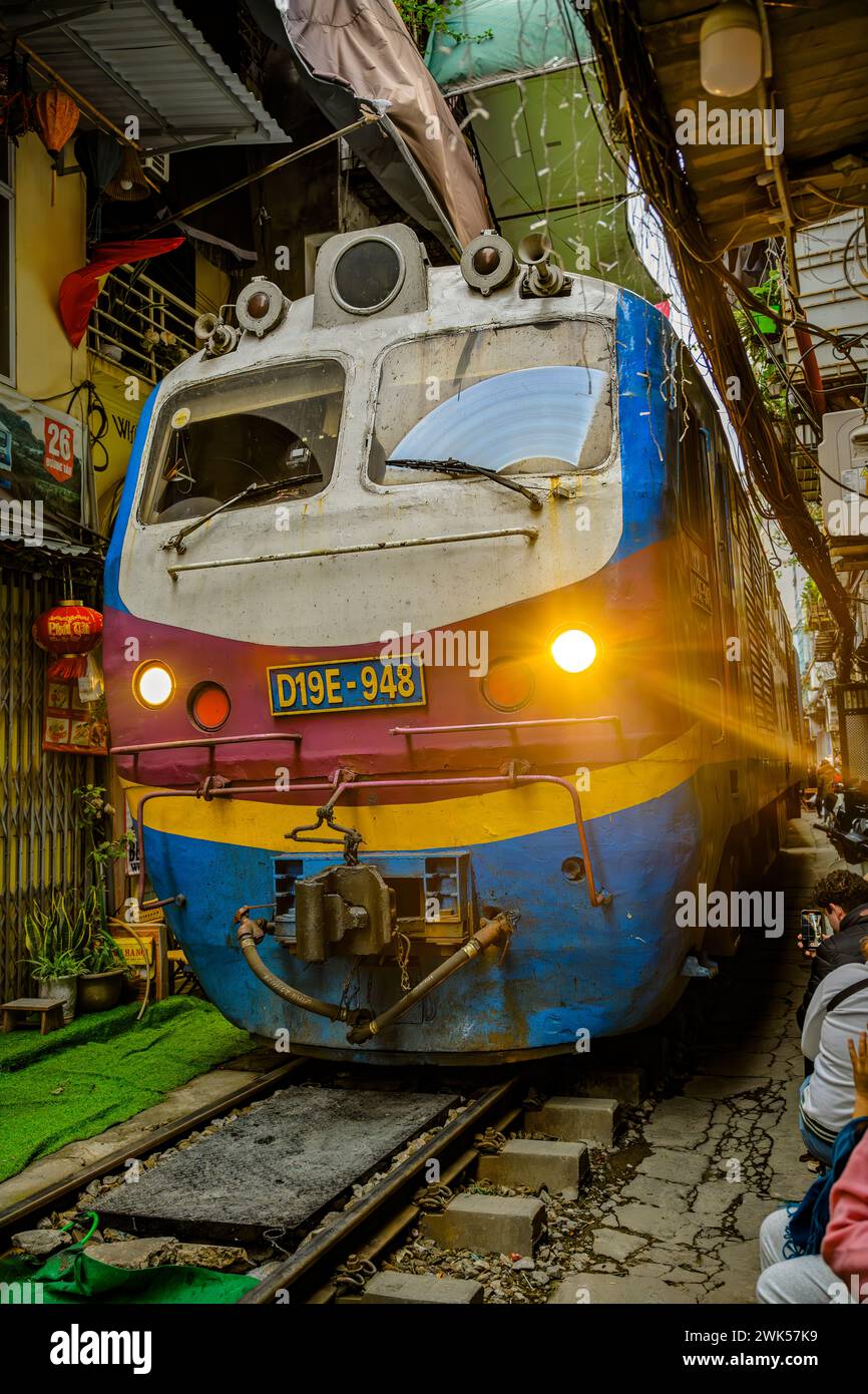 An approaching Vietnamese railway train on Train Street, Hanoi, Vietnam Stock Photo