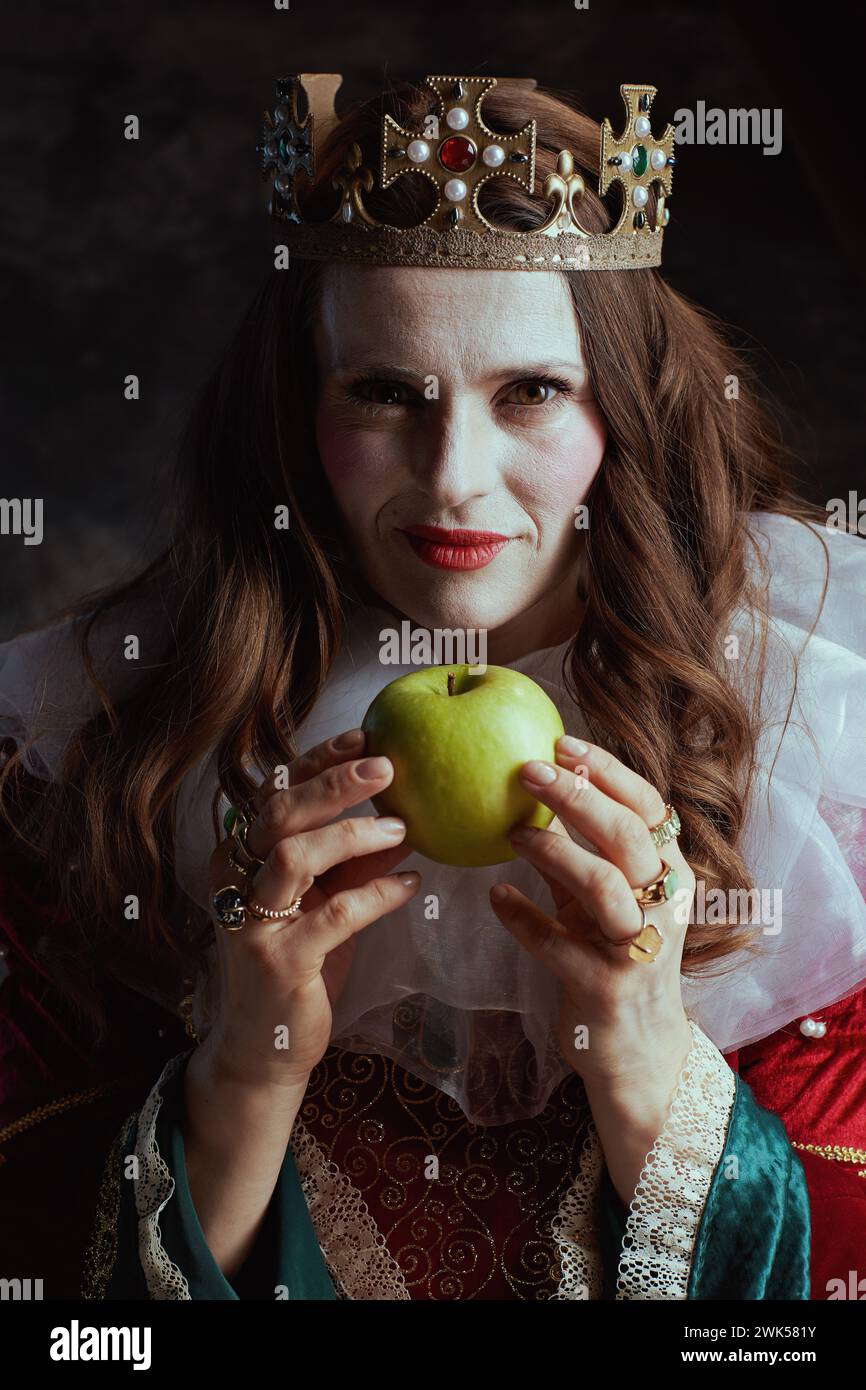 insidious medieval queen in red dress with green apple, white collar