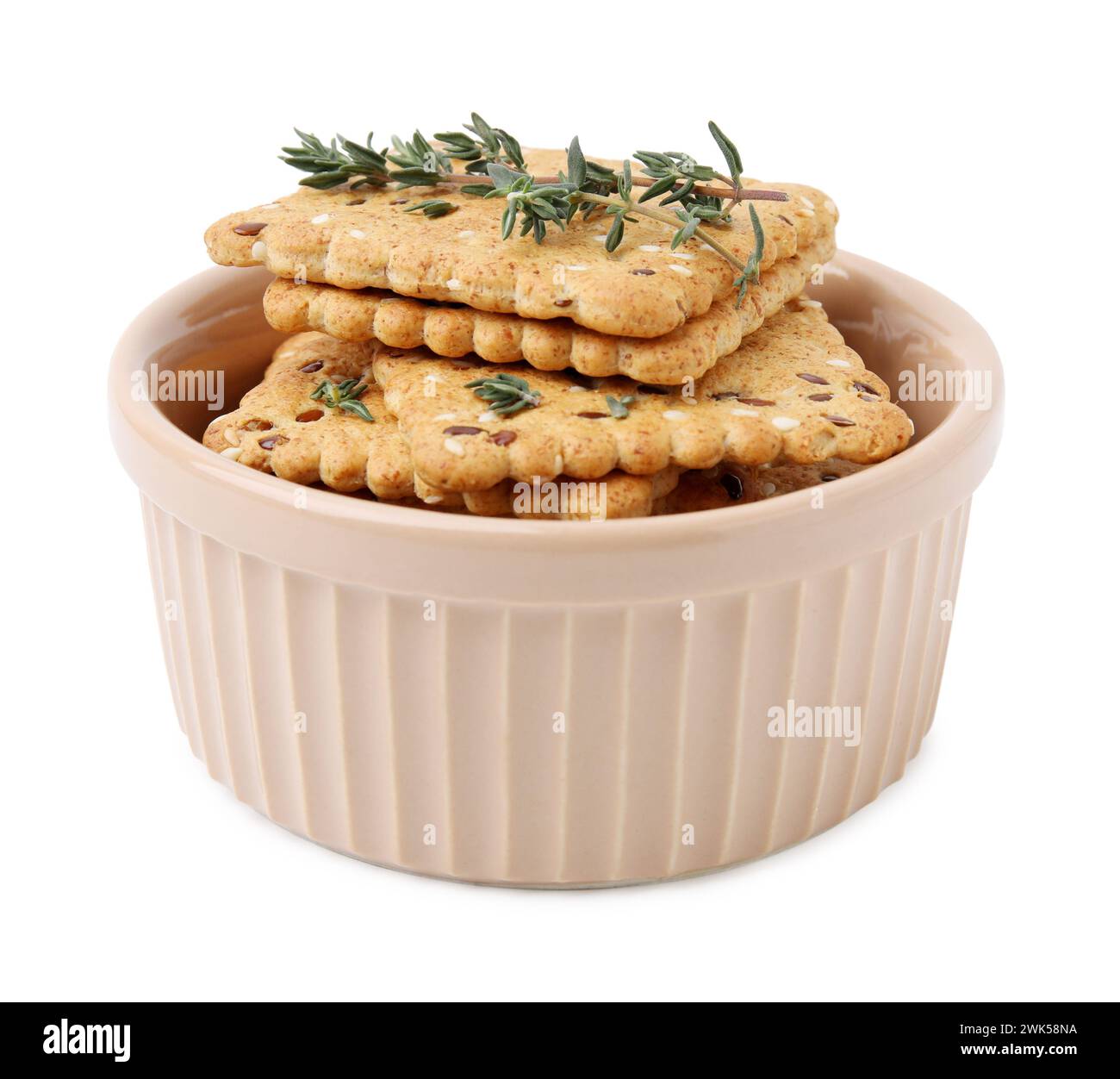 Cereal crackers with flax, sesame seeds and thyme in bowl isolated on ...