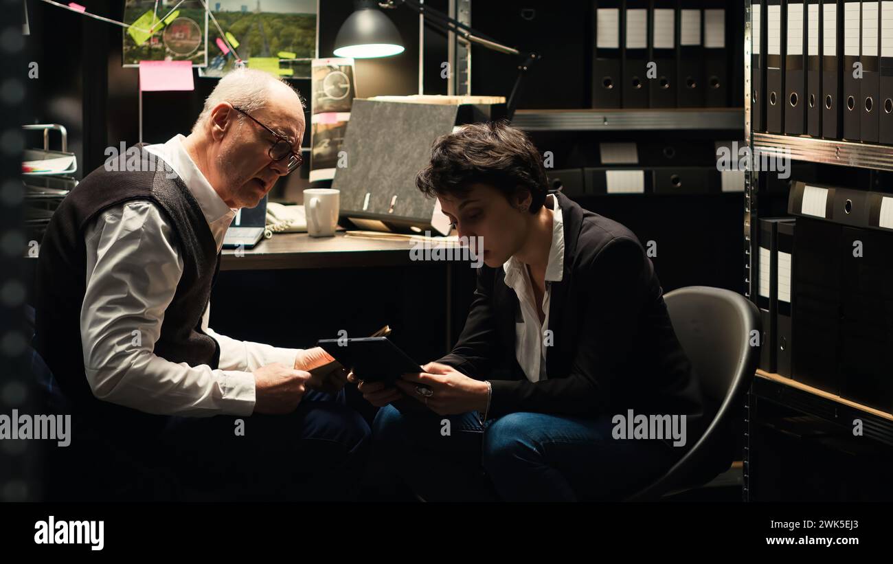 Law agents analyzing forensic evidence in incident room, evaluating