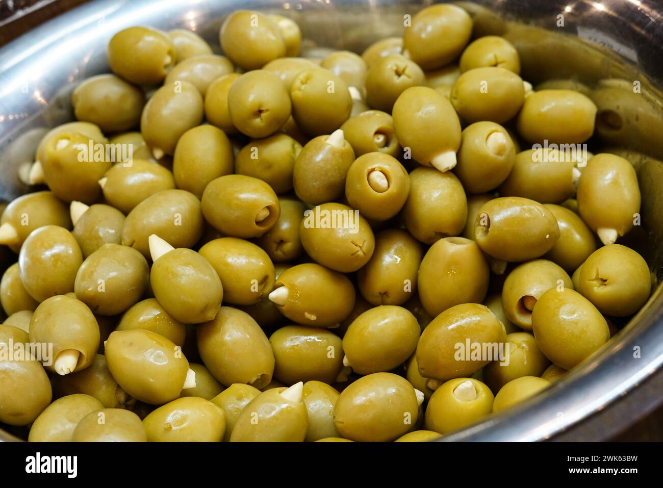 Green olives in a silver bowl. Stock Photo