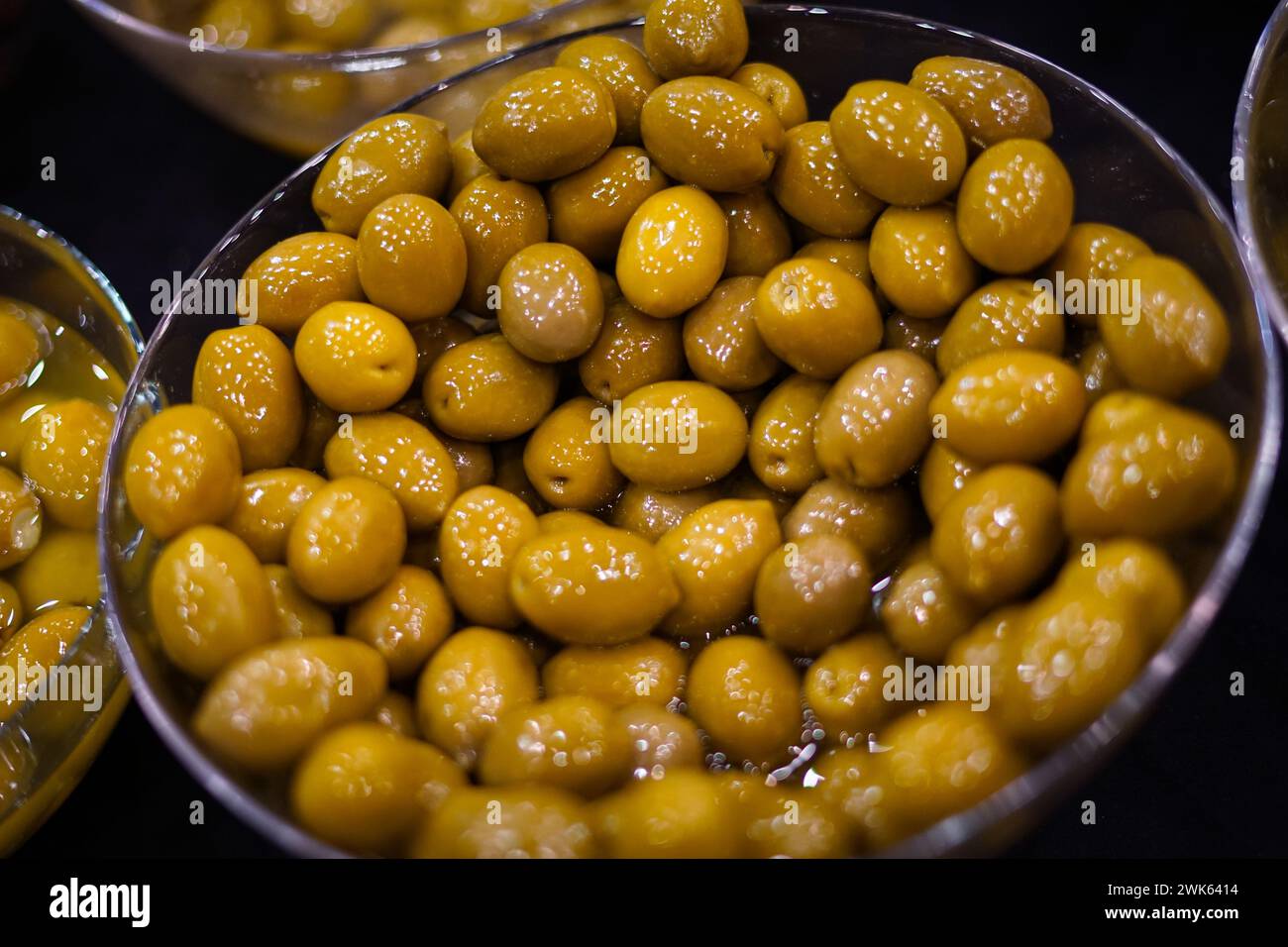 Green olives in a silver bowl. Stock Photo