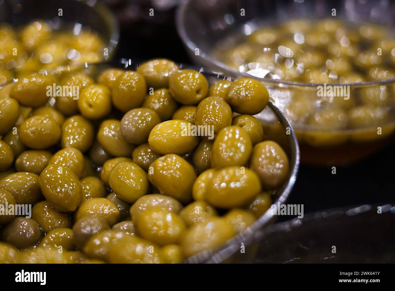 Green olives in a glass bowl. Stock Photo