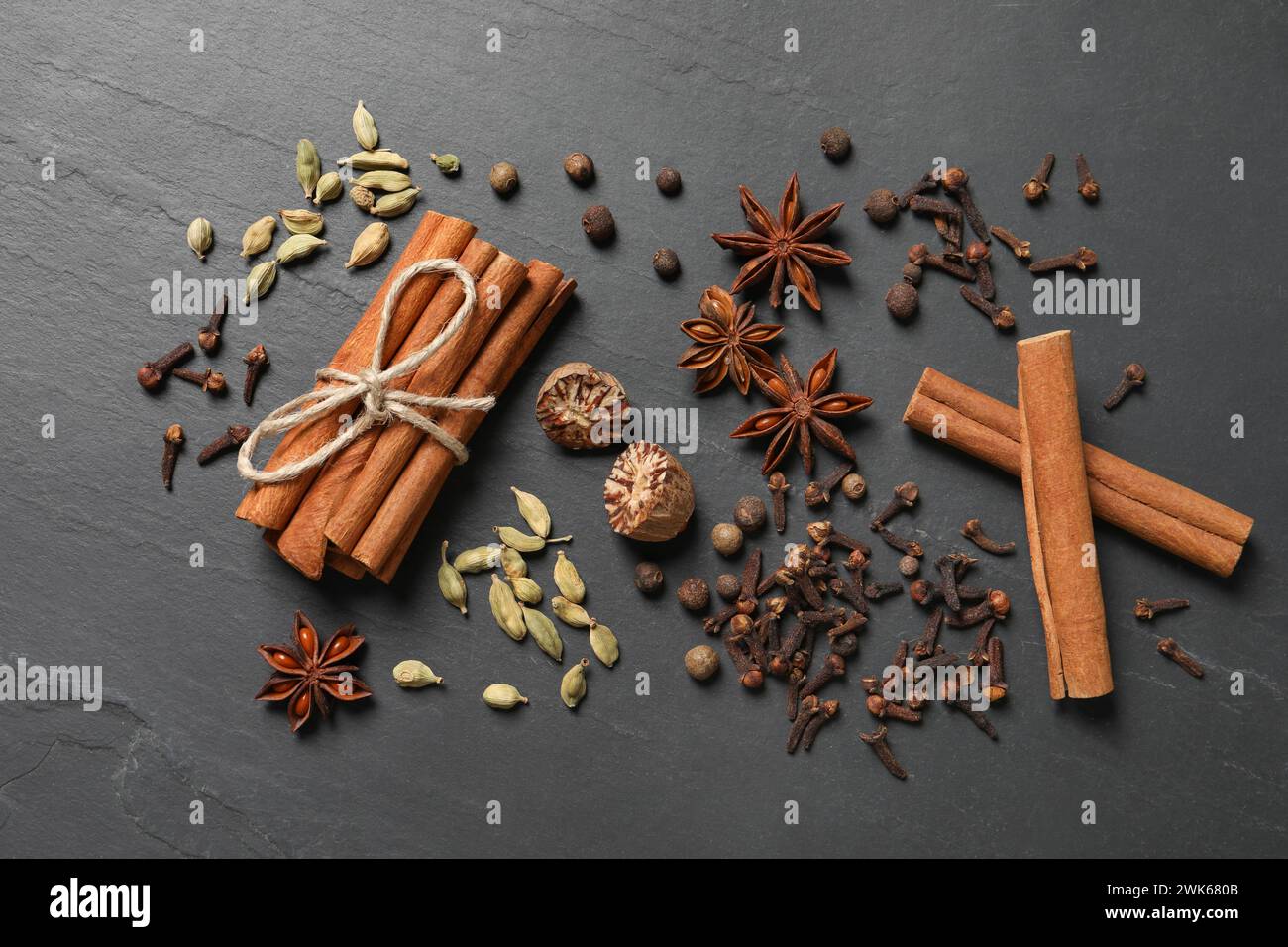 Different spices on dark gray textured table, flat lay Stock Photo