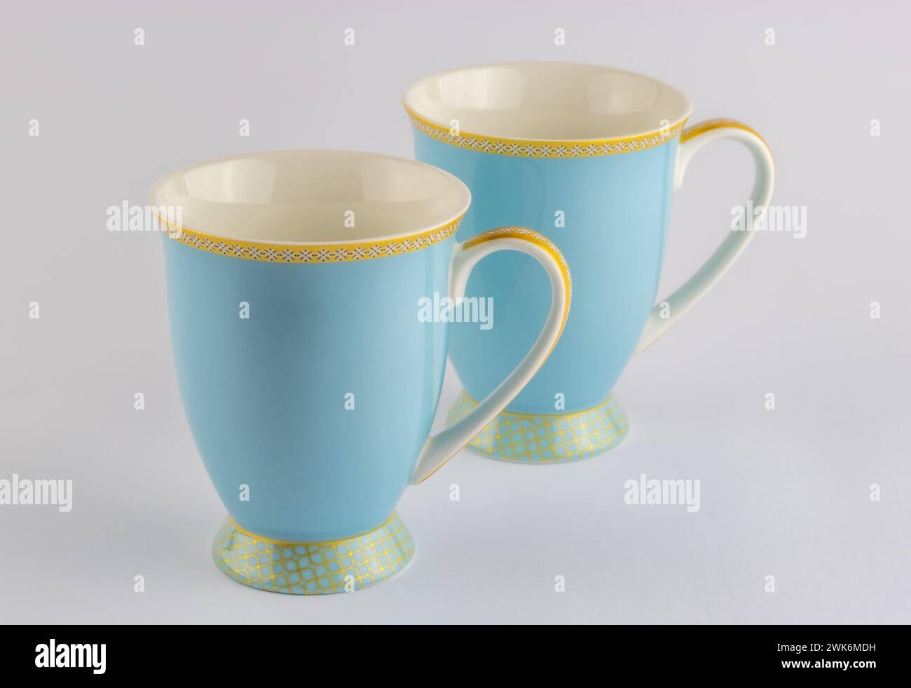 Two blue and gold tea or coffee cups isolated on white background Stock Photo
