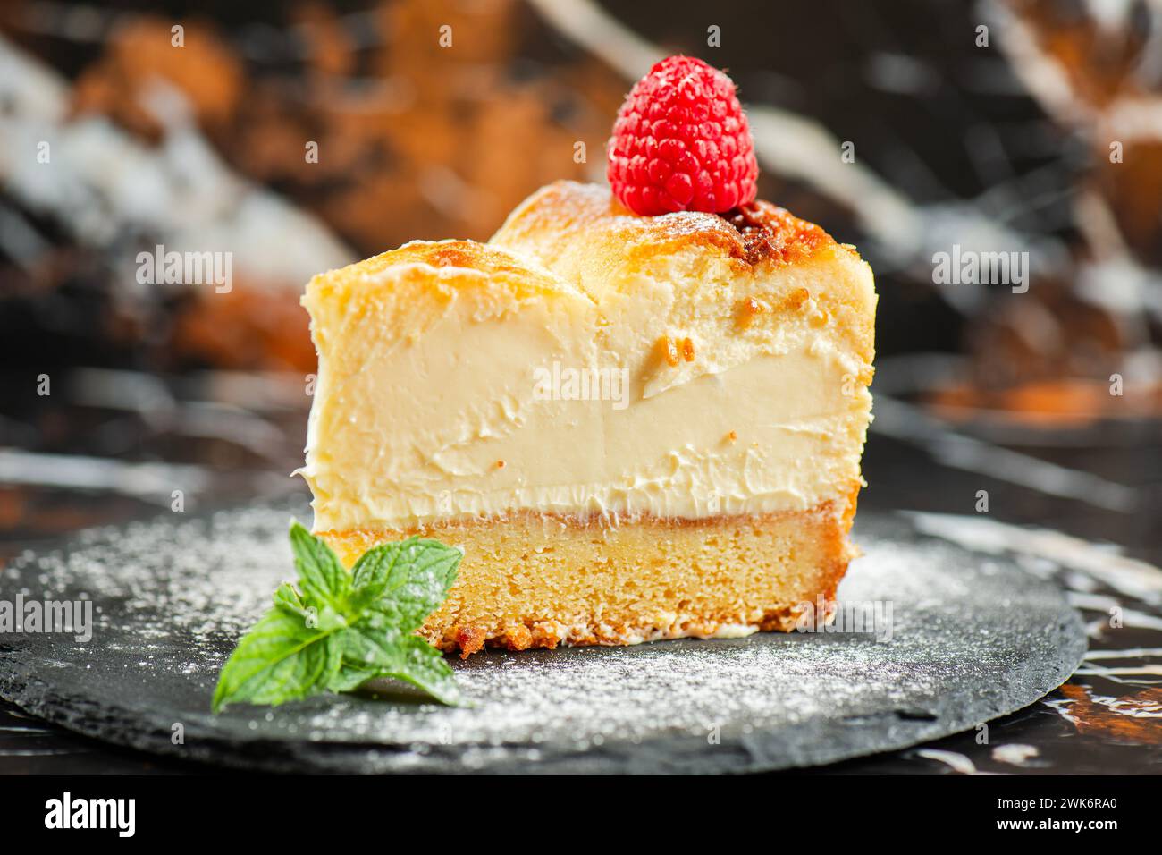Delicious soft-baked creamy Patterson cheesecake with a spongecake base. Stock Photo