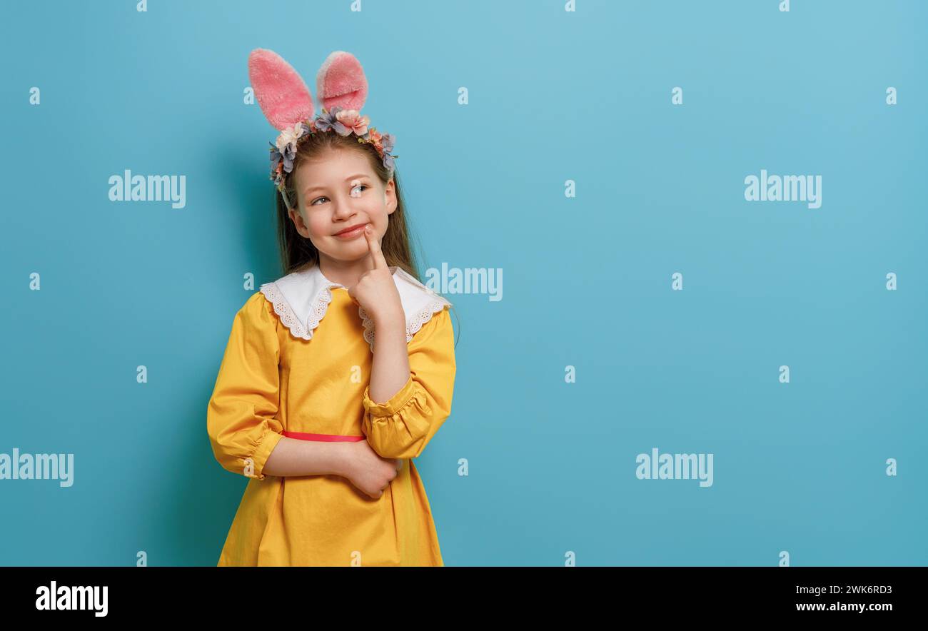Cute little child wearing bunny ears on Easter day. Stock Photo